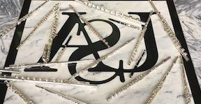 Pictured is an overhead shot of flutes placed artistically on the floor of the Laidlaw Performing Arts Center lobby.