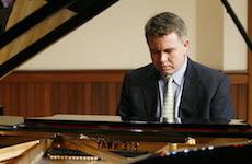 Pictured at the keyboard on the Laidlaw stage is Dr. Robert Holm, USA piano faculty.