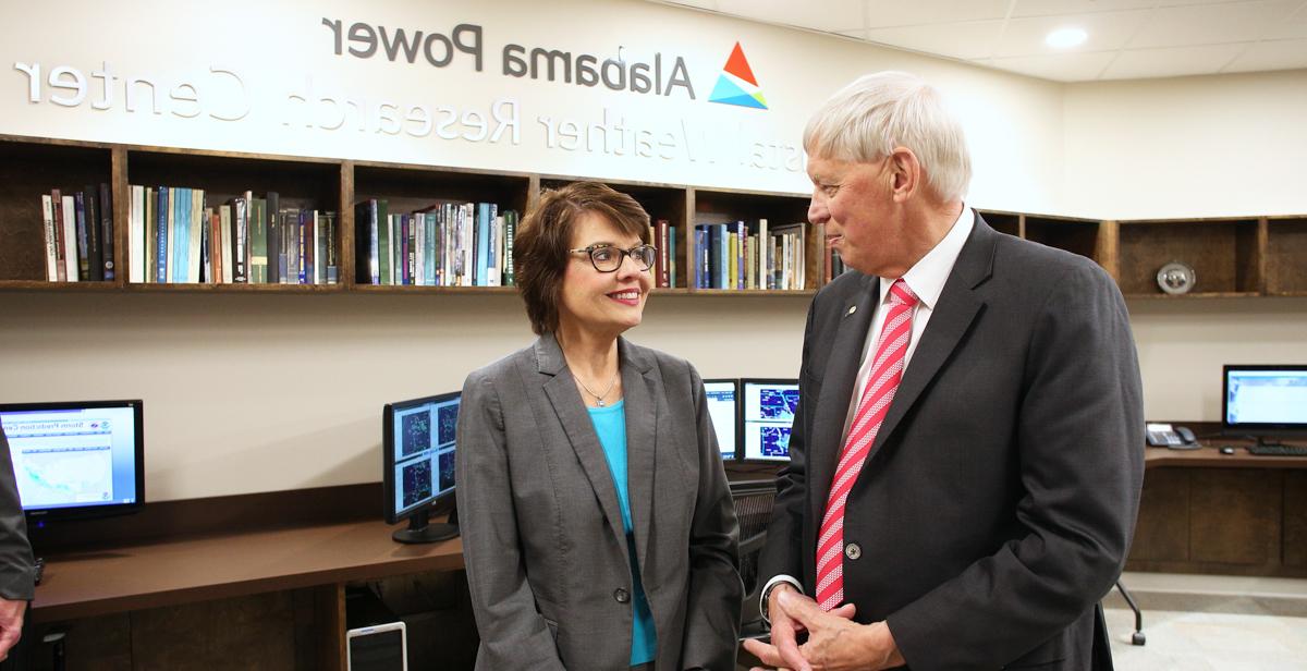 Dr. Tony Waldrop, University of South Alabama president, talks with Beth Thomas, corporate communications manager for Alabama Power, inside the new Alabama Power USA Coastal Weather Research Center. The center provides weather forecasting to more than 100 clients.  data-lightbox='featured'