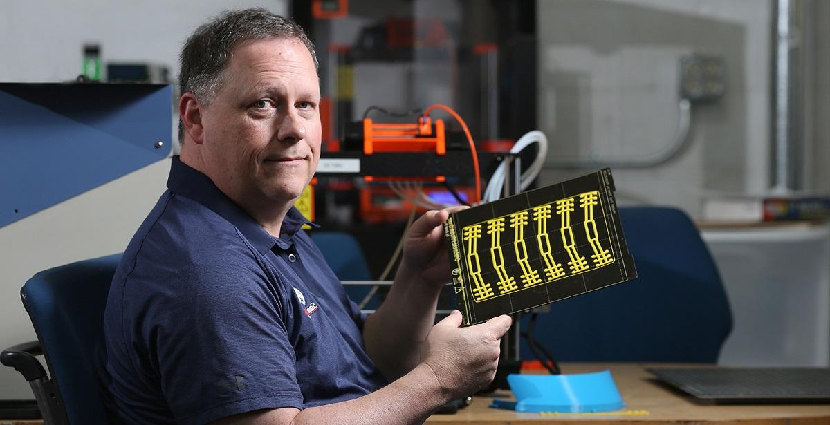 Ricky Green, an information technology instructor at the University of South Alabama, uses 3D printers to produce parts that will be put together to make face shields for healthcare workers. 